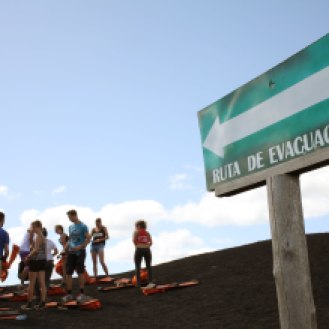 A cheeky evacuation sign points to the area where you go off the side of Cerro Negro. Photo: Alex Washburn